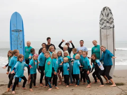 a group of people posing for a photo with surfboards