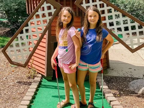 two girls standing on a porch