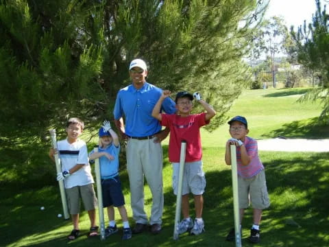 a group of people posing for a photo with golf clubs