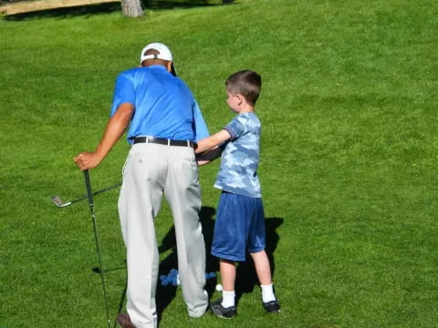 a man and a boy playing golf