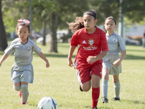 a group of young girls playing football