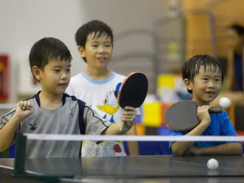 a group of boys playing pool