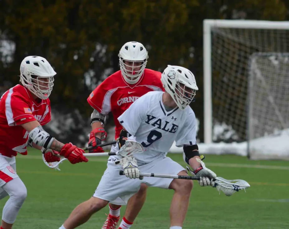 a group of men playing lacrosse