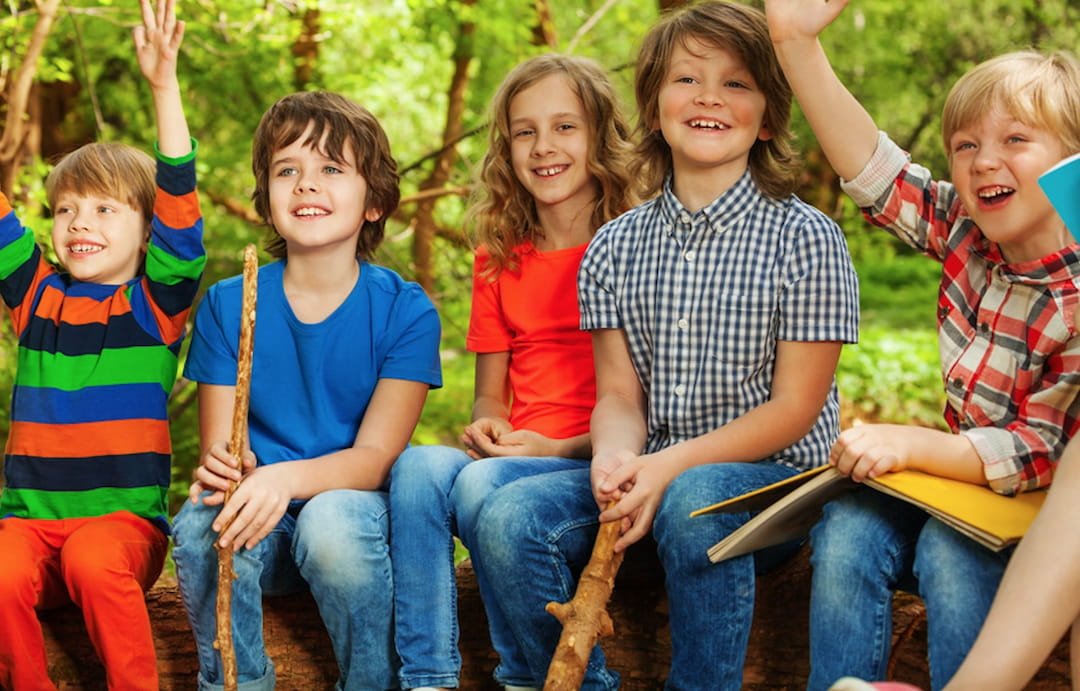 a group of children sitting on a bench