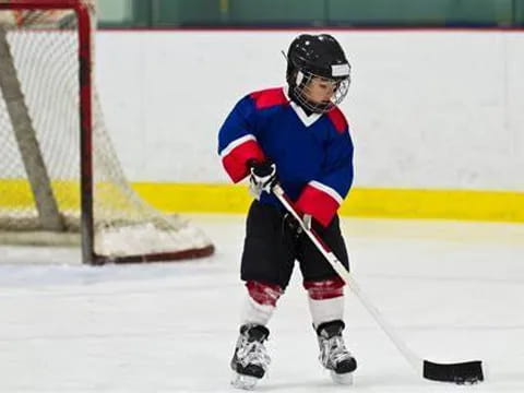 a young boy playing hockey