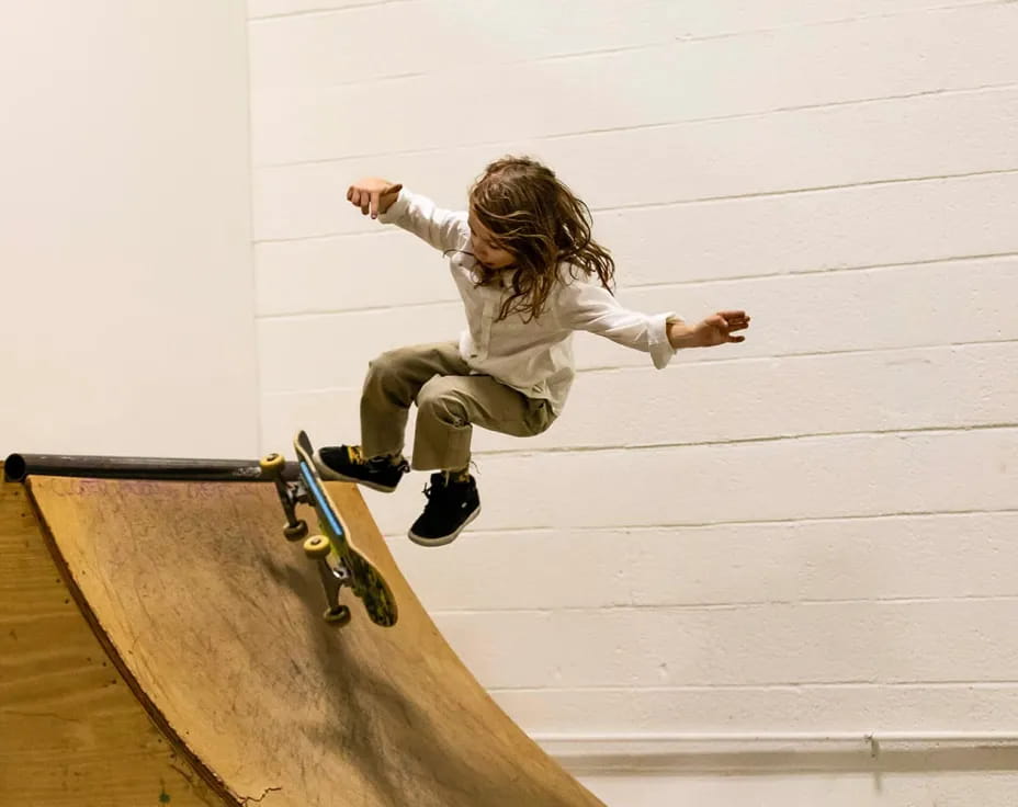 a girl jumping on a skateboard