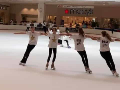 a group of women ice skating