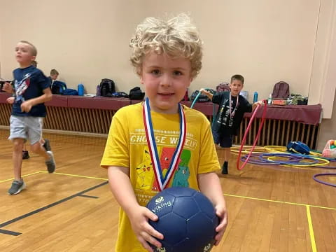 a boy holding a ball