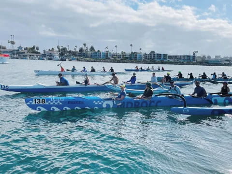 a group of people in boats on water