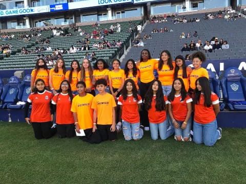 a group of people wearing orange shirts