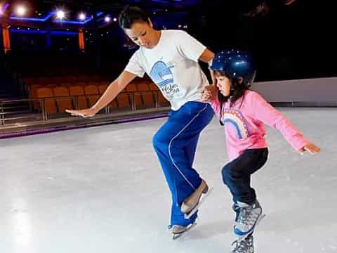 a man and a girl ice skating