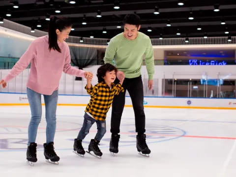 a man and woman and a child ice skating