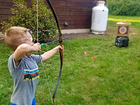 two boys playing with bows and arrows