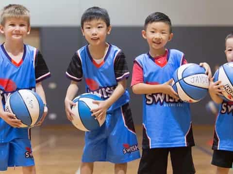 a group of boys holding balls