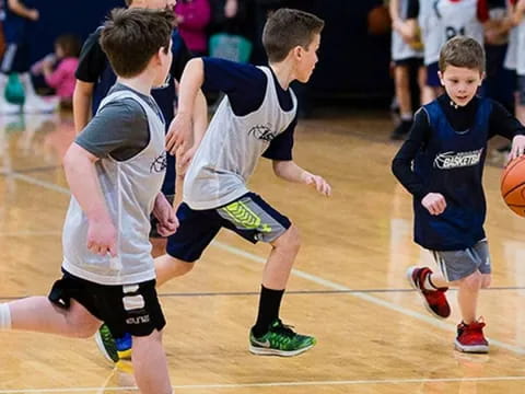 a group of boys playing basketball