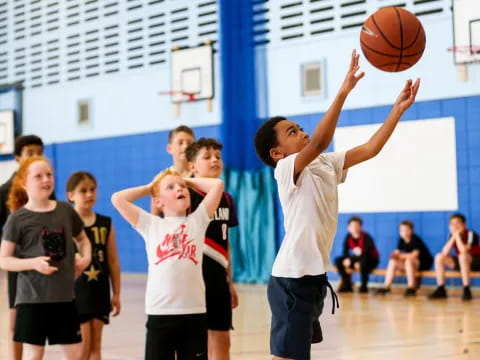 a group of kids playing basketball