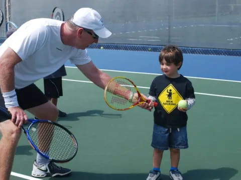 a man and a boy playing tennis