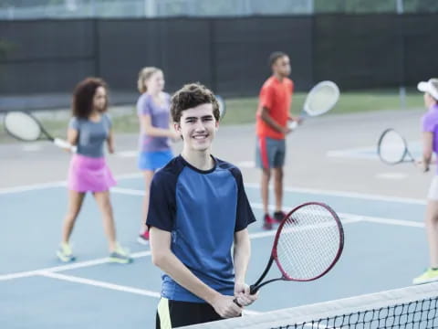 a boy holding a tennis racket