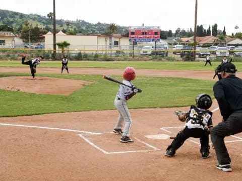 a baseball player prepares to swing a bat