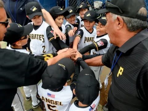 a man shaking hands with a group of people in uniform