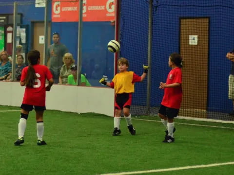 a group of kids playing football