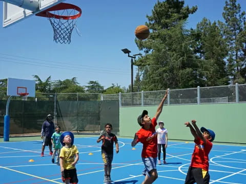 a group of kids playing basketball