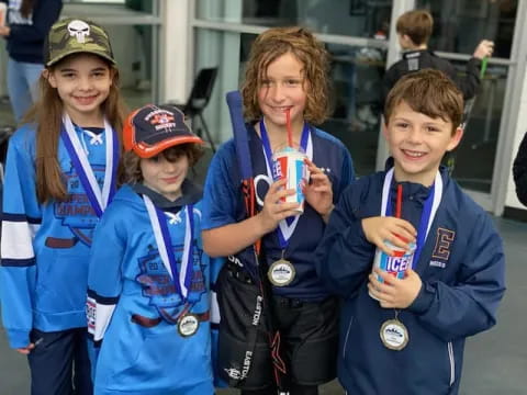 a group of kids holding medals