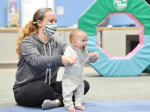 a person wearing a mask and holding a baby