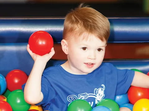 a boy holding a ball