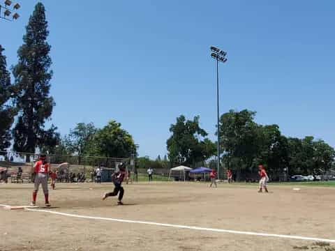 a group of people playing baseball