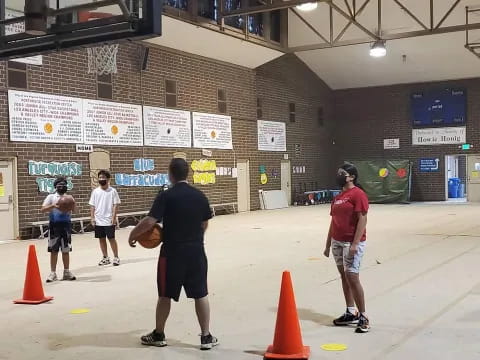 a group of people playing basketball