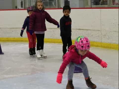 a group of kids on an ice rink