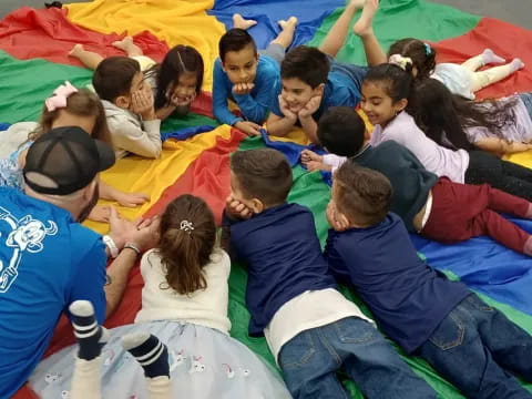 a group of children lying on a blanket