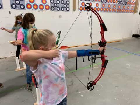 a group of girls practicing archery