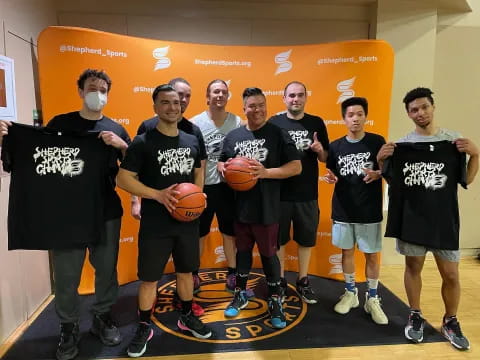 a group of men posing for a picture with basketballs