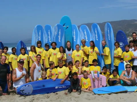 a group of people posing for a photo with surfboards