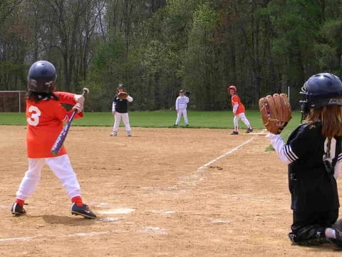 kids playing baseball on a field