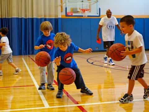 kids playing basketball on a court