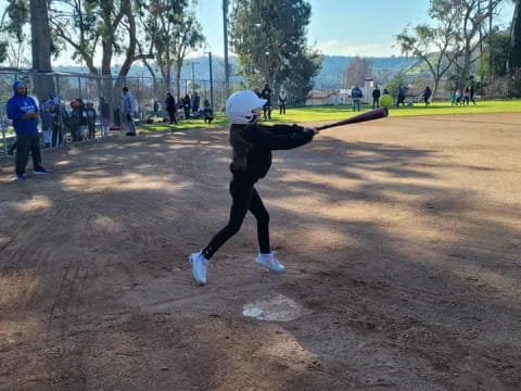 a person swinging a baseball bat