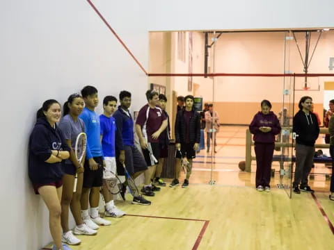 a group of people holding tennis rackets