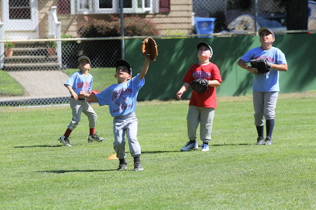 kids playing baseball on a field