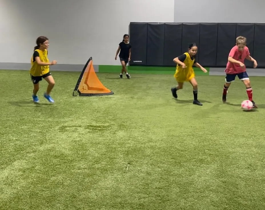 a group of kids playing football