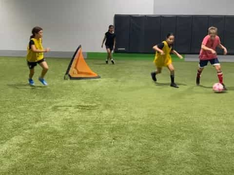 a group of kids playing football