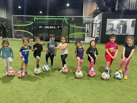 a group of kids with football balls