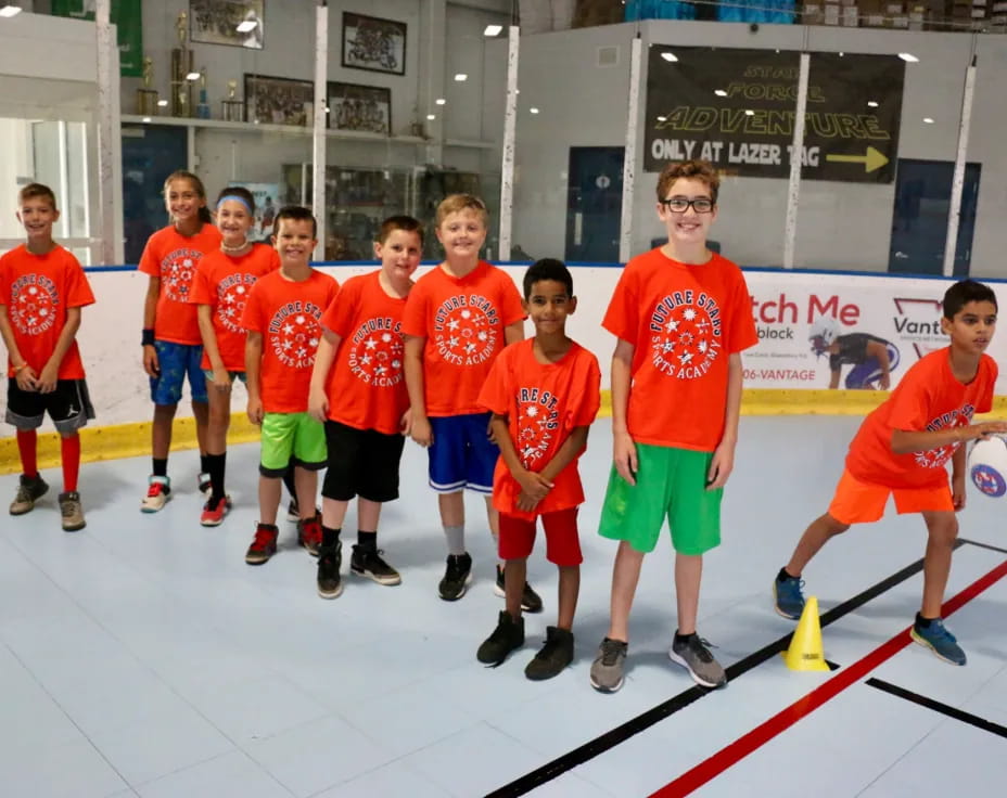 a group of boys in orange shirts