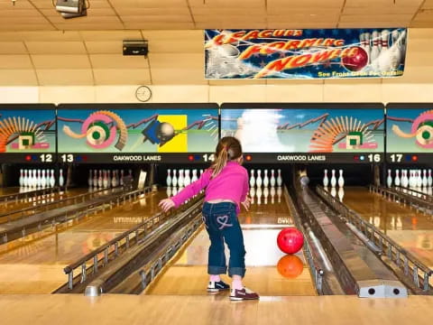 a girl bowling in a bowling alley