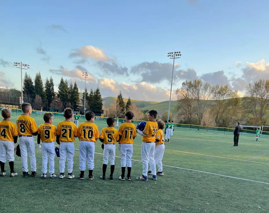 a group of people in sports uniforms standing on a field