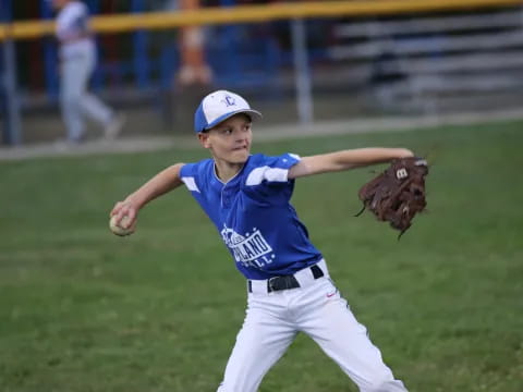 a young boy throwing a baseball