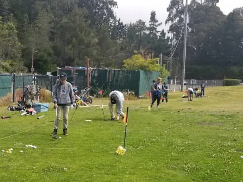 a group of people playing with sticks