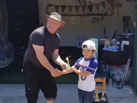 a man and a boy holding a small bird